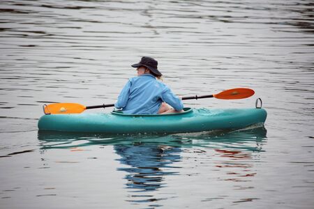 Woman in Cayak on Calm Waterの写真素材
