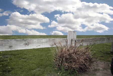 Bright Sky and Grass With Wooden Rail Fenceの写真素材