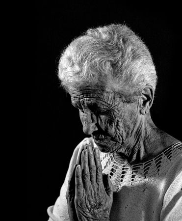 Senior Citizen in Deep Prayer in Monochromeの写真素材