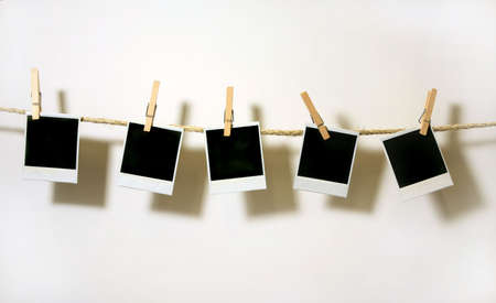 Old Film Blanks Hanging on a Rope Held By Clothespinsの写真素材