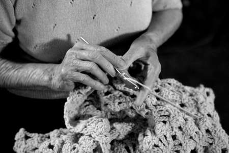 Elderly Woman Crocheting a  Blanket in Monochromeの写真素材