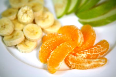 Oranges Bananas and Apples Prepared on a  White Plate Close Up High DOFの写真素材