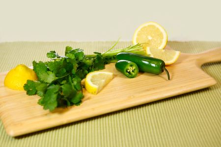 Salsa Ingredients Cilantro Jalapeno and Lemon on a Cutting Boardの写真素材