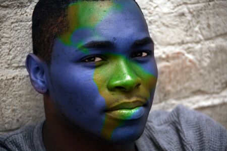 African American Male Portrait With Globe Painted on His Faceの写真素材