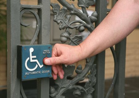 Handicap Access Automatic Door Button Being Pushed by a Gentlemanの写真素材