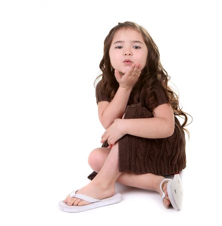 Beautiful Young Child Blowing a Kiss on White Backgroundの写真素材