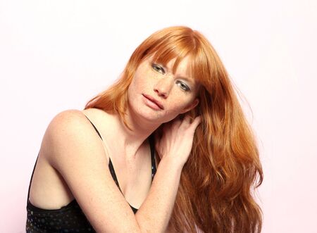 Sexy Red Head Woman Running Fingers Through Her Long Hairの写真素材