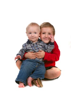 Handsome Young Brothers Showing Affection on Whiteの写真素材