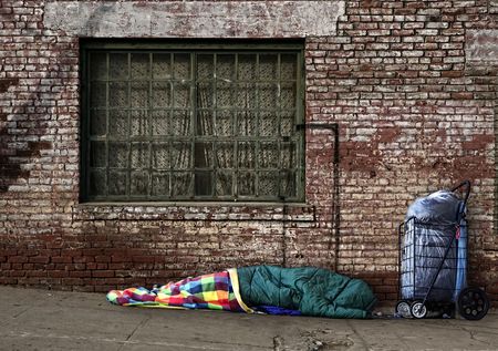 Homeless Soul Sleeping on the Streets in a Sleeping Bag Outdoorsの写真素材