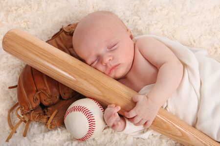 Sweet Little Baby Boy Holding a Baseball Bat With Glove and Ballの写真素材