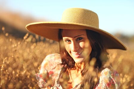 Beautiful Woman in a Field During Summer With Hat