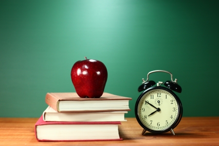 Back to School Books, Apple and Clock on Deskの写真素材