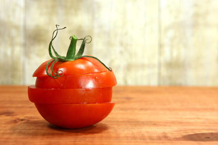 Red Hothouse Tomatoes on a Rustic Wood Plankの写真素材