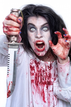 Scary Horror Image of a Bleeding Psychotic Woman With Knifeの写真素材