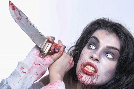 Scary Horror Image of a Bleeding Psychotic Woman With Knifeの写真素材