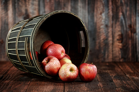 Rustic Barrel Full of Red Apples on Wood Grunge  の写真素材