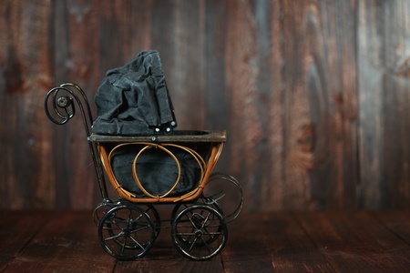 Antique Infant Baby Cradle on Grunge Wooden の写真素材