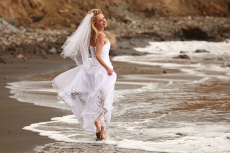 Beautiful Blonde Bride at the Beach on Her Wedding Dayのeditorial素材