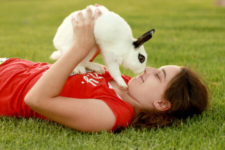 A Child and Her Pet Bunny Playing Outdoorsのeditorial素材