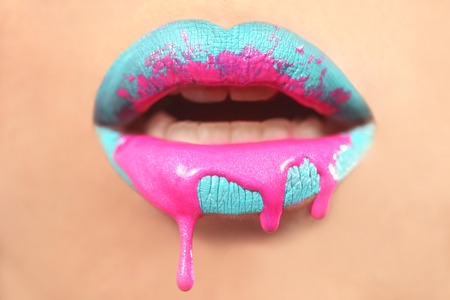 Dripping Creative Make Up on the Lips of a Fashion Model