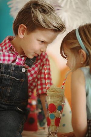 Small Children Enjoying a Fashionable Outdoor Birthday Partyの写真素材