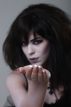 Dark Gothic Expressive Woman on Plain Backgroundの写真素材