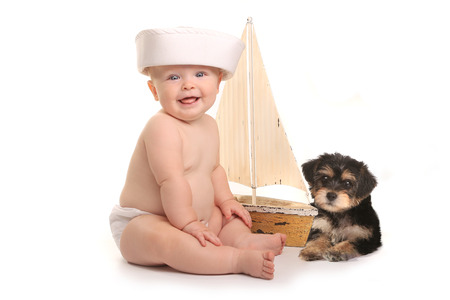 Cute Baby Boy With His Pet Teacup Yorkie Puppyの写真素材