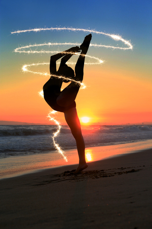 Beautiful Young Dancer at the Beach During Sunsetの写真素材