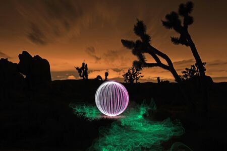 Girl Light Painted in the Desert Under the Night Skyの写真素材