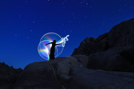 Girl Light Painted in the Desert Under the Night Skyの写真素材