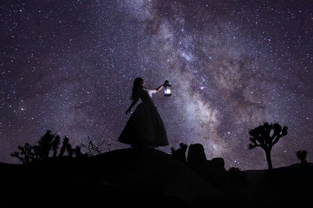 Girl Light Painted in the Desert Under the Night Skyの写真素材