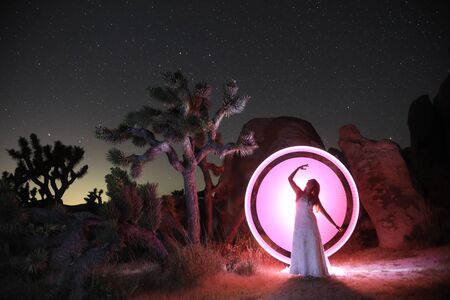 Girl Light Painted in the Desert Under the Night Skyの写真素材