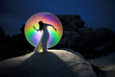 Girl Light Painted in the Desert Under the Night Skyの写真素材