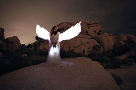 Girl Light Painted in the Desert Under the Night Skyの写真素材