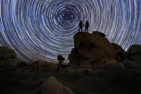 Happy Couple Silhouette Under the Stars at Nightの写真素材