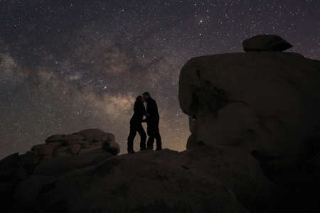 Happy Couple Silhouette Under the Stars at Nightの写真素材