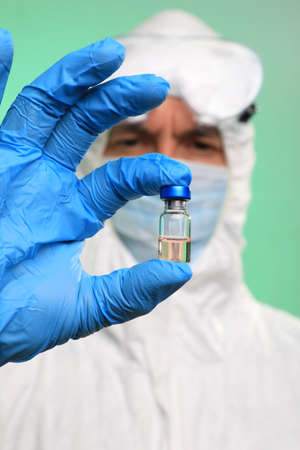Virus Lab Technician Doctor Handling a Vial of Vaccineの写真素材