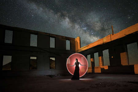 Fashionable Model Posing in the Desert at Night With Milky Wayの写真素材