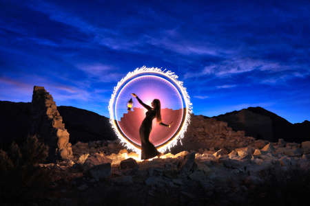 Beautiful Woman Model Posing in the Desert at Nightの写真素材