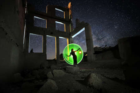 Fashionable Model Posing in the Desert at Night With Milky Wayの写真素材