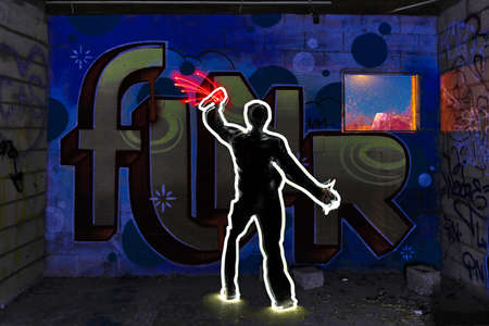 Cool Light Painted Image of Man Tagging with Spray Paintの写真素材