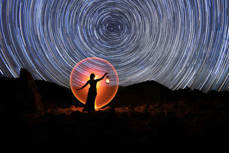 Beautiful Woman Model Posing in the Desert at Nightの写真素材