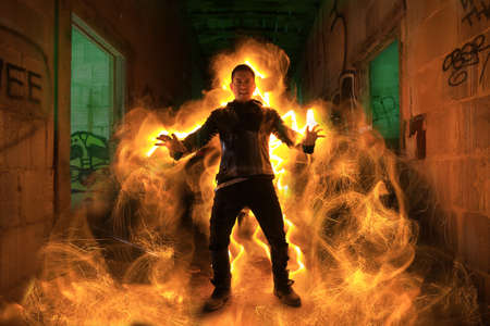 Burning Man in Abandoned Building Conjuring Fireの写真素材