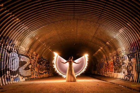 Angelic Woman Light Painted With Wings in a Sewage Tunnelのeditorial素材