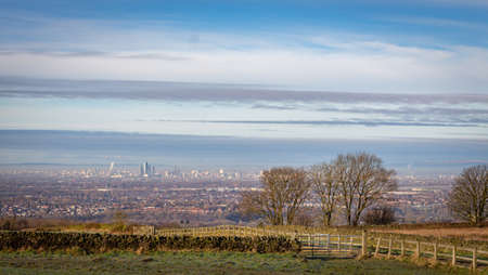 View of Manchester city with hazy winter sky, from Werneth Low Country Park on the borders of Stockport and Tameside,  Greater Manchester.の写真素材