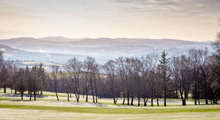 Winter view of golf course with hills in the distance. Werneth Low Country Park on the borders of Stockport and Tameside,  Greater Manchester, UK.の写真素材
