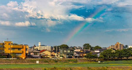 Rainbow seen in summer above the banks of the Saigawa River, Kanazawa, Japan.の写真素材