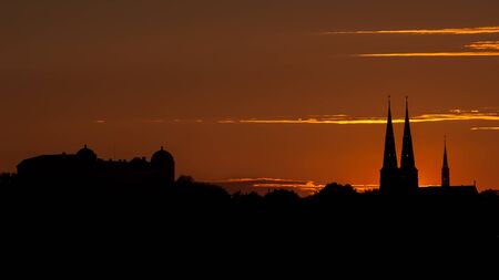 Uppsala Skyline in the sunset with the silhouettes of Uppsala Castle and Uppsala Cathedral, Swedenの写真素材