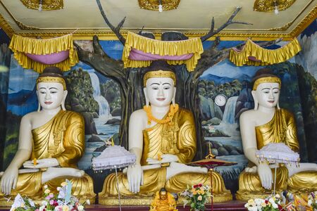 Three Buddha with golden suit in Myanmar templeの写真素材