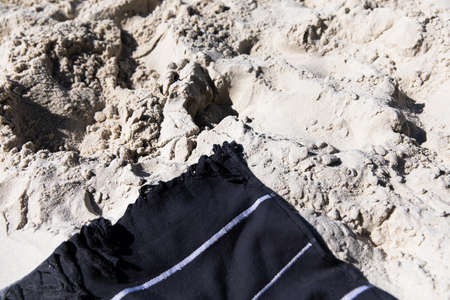A blue towel on a white sandy beachの写真素材